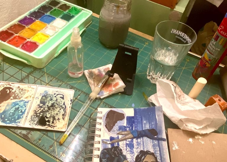 Picture of Takara's paints, paint brush and a canvas on which she is painting "It Almost Worked".  