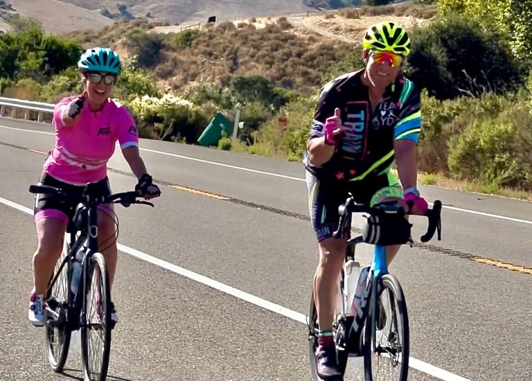 A man and a women cycling outside
