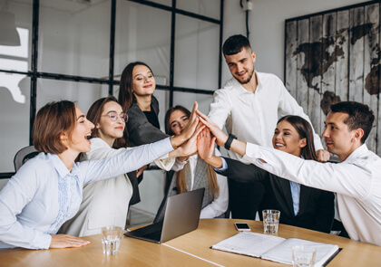 a group of business people giving high five fingers up