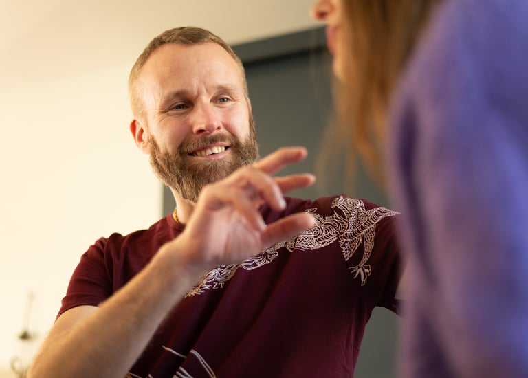 A man clearing energy blockages of a woman