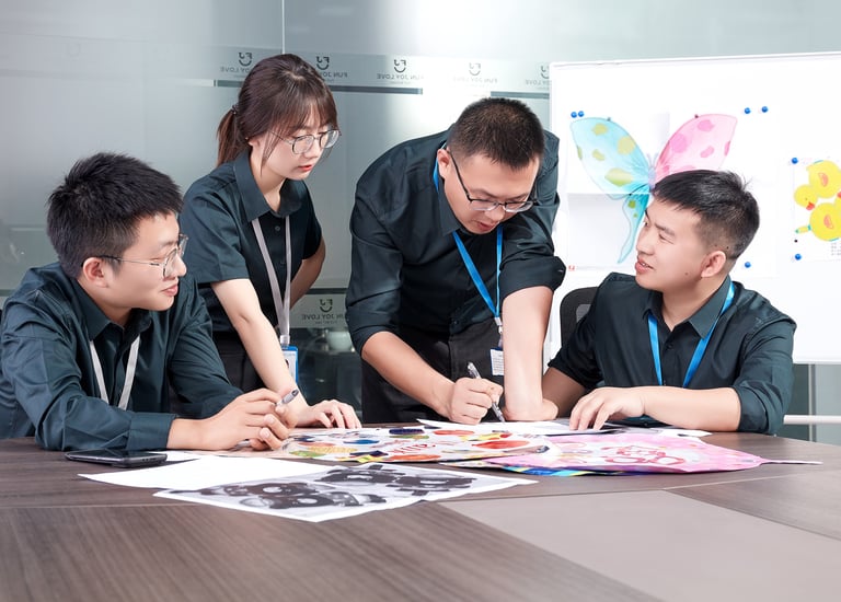 Professional design team collaborating on a creative project in a modern office meeting room.