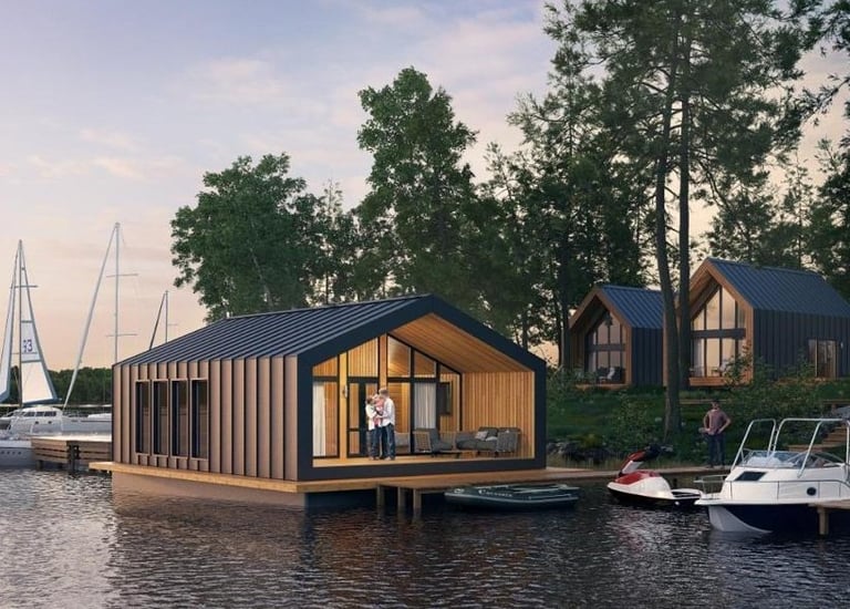 Modern floating house and lakeside cabins with boats docked at a scenic waterfront resort.