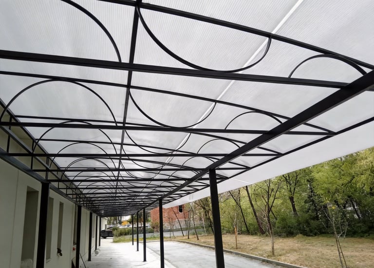 Modern outdoor polycarbonate awning with a black metal frame and decorative arches.