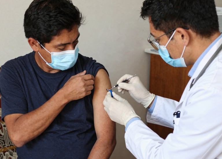 A doctor and an interpreter kindly assisting a migrant patient in a clinic setting.