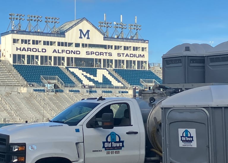 Truck at u of Maine with portable toilets