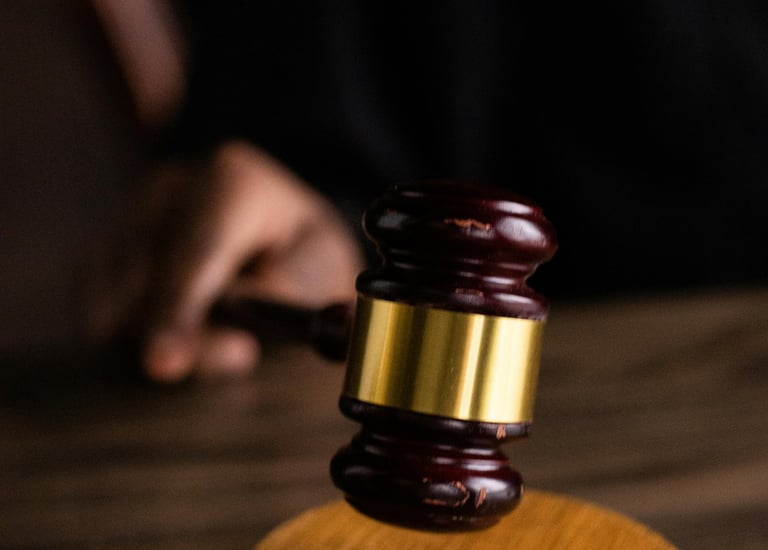 a judge's gavel with a gavel on a wooden table