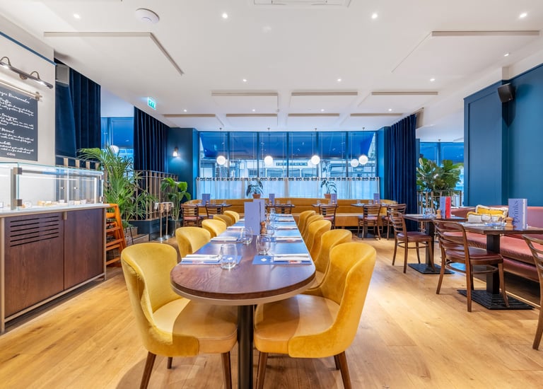 a restaurant with a long table and chairs
