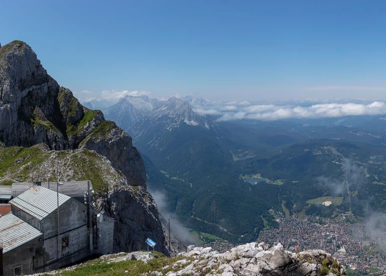 Panoramic view of Garmisch-Partenkirchen from the rocky summit of Zugspitze in the Bavarian Alps.