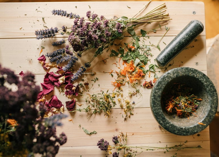 a mortar and herbs on the table