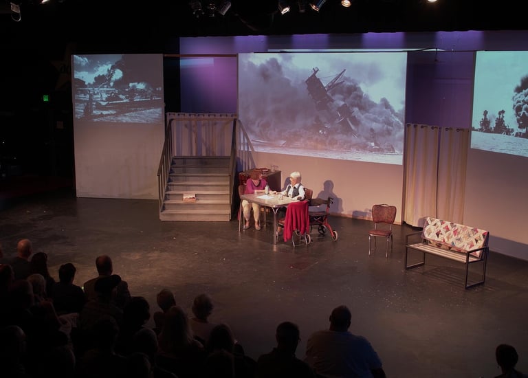 Two women sitting in front of projected images of the attach on Pearl Harbor.