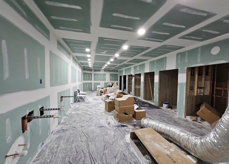 a room with drywall repairs and spackled walls
