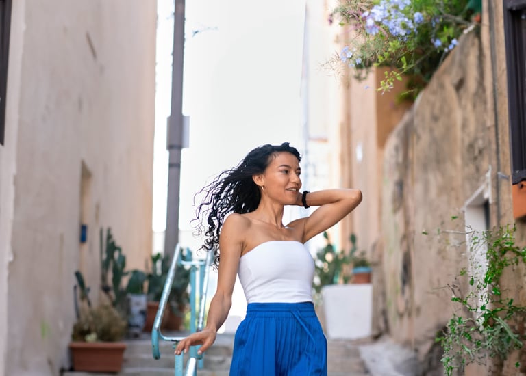 A girl walking down stairs with a radiant smile, elegantly captured in a candid moment of joy.