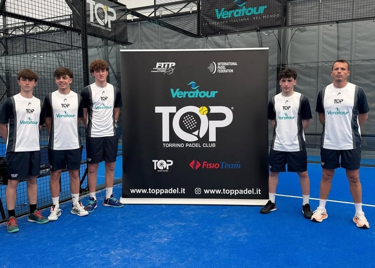 Padel players posing on a blue indoor court by a Torrino Padel Club sponsor banner.