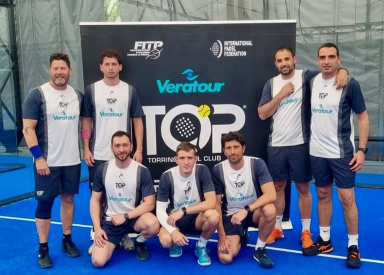 A group of male padel players in Veratour team uniforms posing on a blue indoor padel court.