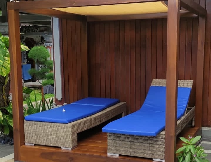 a couple of lounge chairs sitting next to a pool