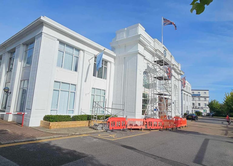 Exterior painting of large white commercial building with scaffolding in Croydon, Pure Perfection