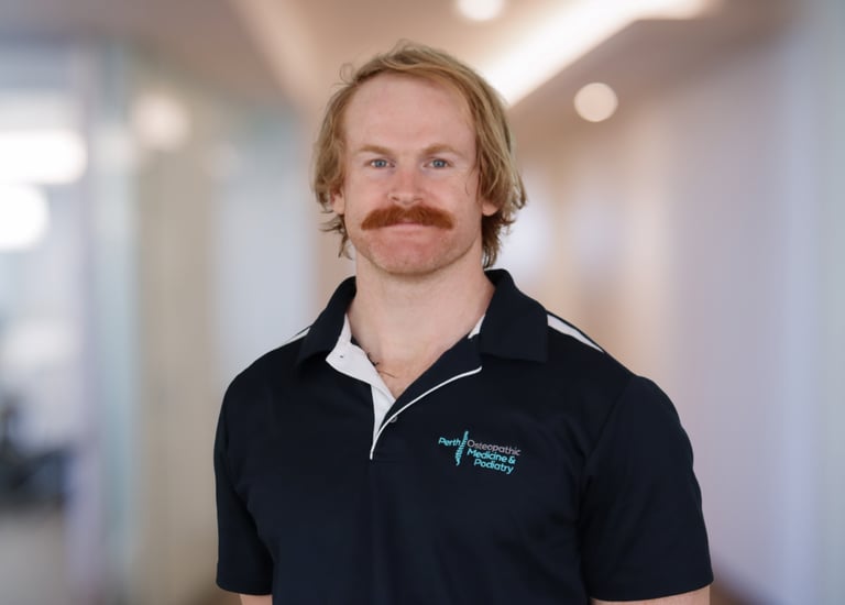 Advanced Sports Osteopath Dr Ashby Smith posing for a headshot at Perth Osteopathic Medicine