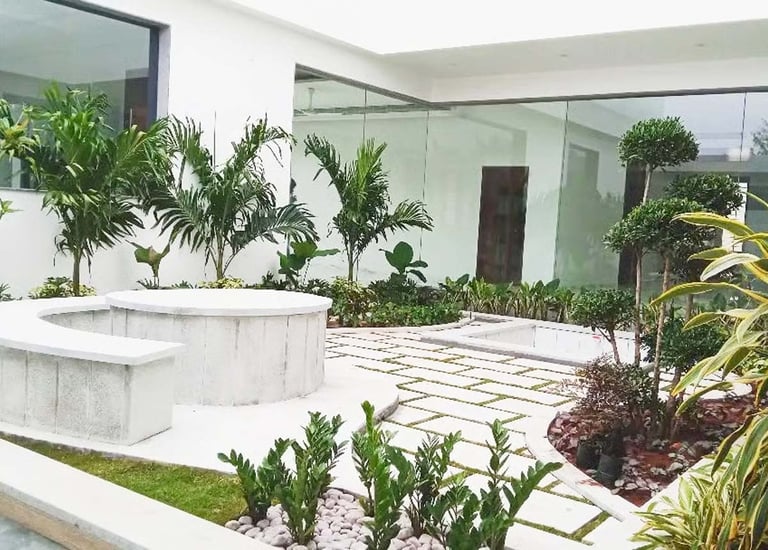 Rustic courtyard with clay pots and decorative planters by Garden Designers