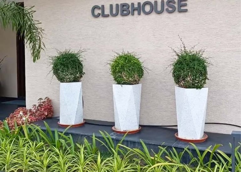 Artistic pottery accents in a heritage-inspired courtyard design by Garden Designers