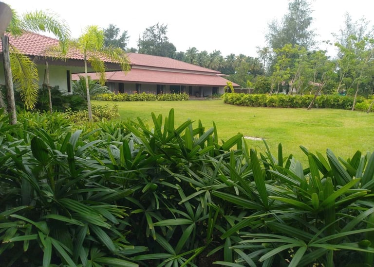 Farmhouse landscape blending rustic charm with native flora by Garden Designers