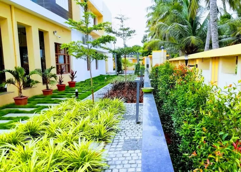 Seamless indoor-outdoor landscape transition with potted greenery and pathway by Garden Designers