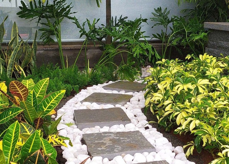 Lush indoor courtyard merging into an outdoor garden by Garden Designers