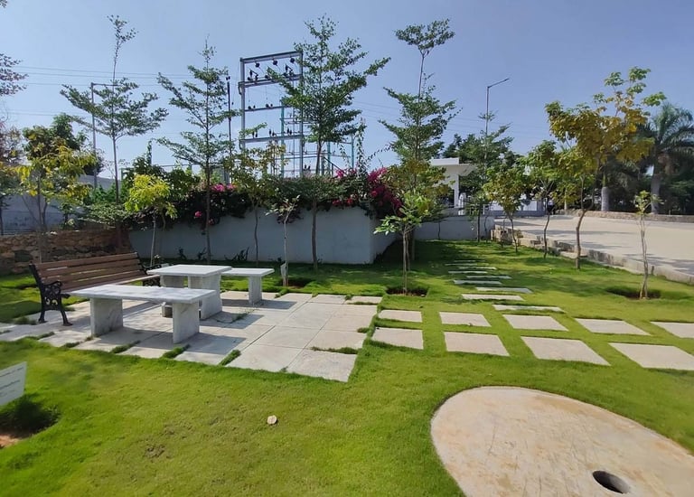 Industrial facility landscape with hardy shrubs and erosion control by Garden Designers