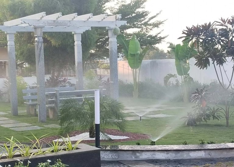 Efficient drip irrigation setup in a well-designed garden by Garden Designers