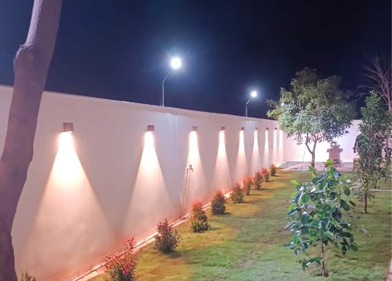 Ambient outdoor lighting creating a cozy night-time garden vibe by Garden Designers