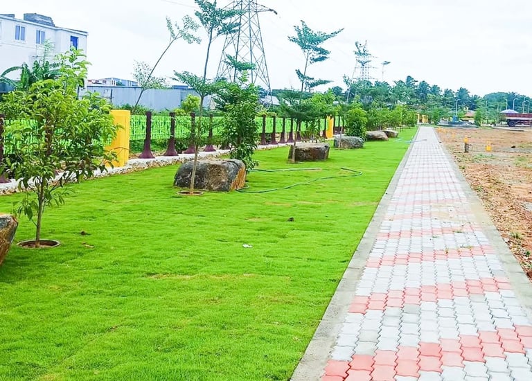 Plot development entrance with landscaped signage and driveways by Garden Designers