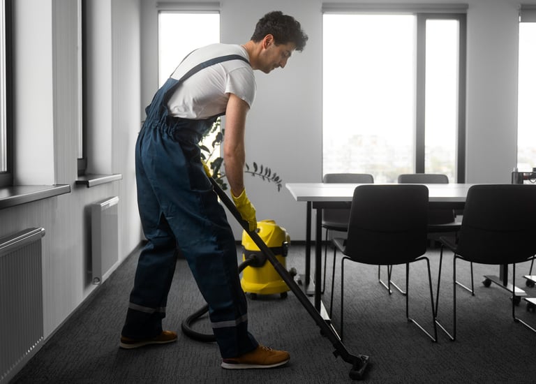 a man in overalls and overalls cleaning a room