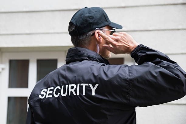 a security officer talking on the phone
