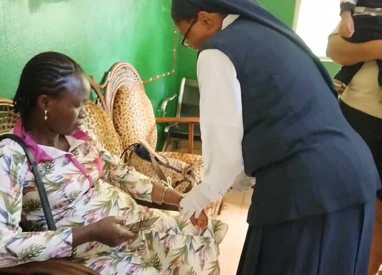 A catholic nun nurse providing medical care to a patient at a community health clinic in Africa.