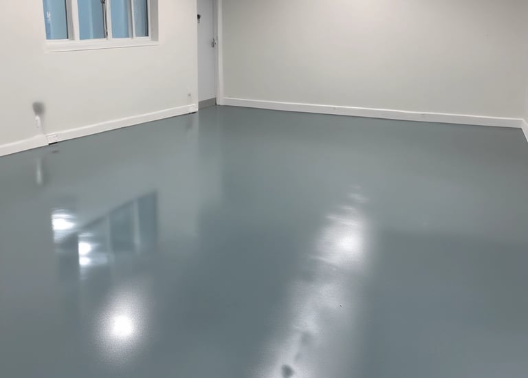 Painter applying fresh, vibrant paint to a residential floor in Terrassa