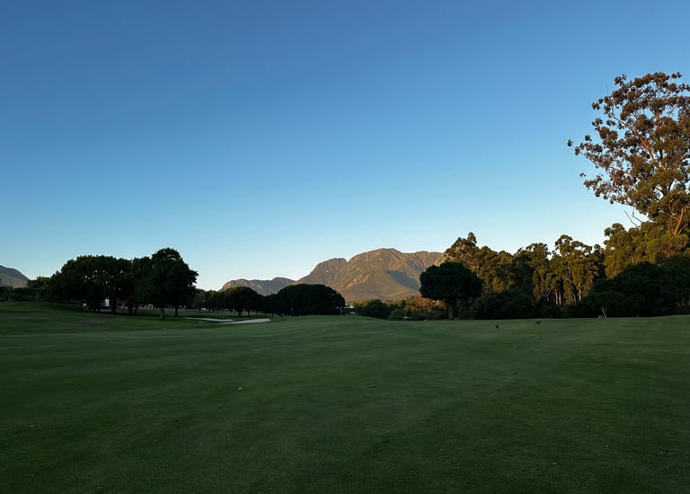 a golf course with a view of the mountains