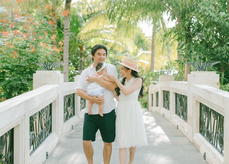 xFamily walking on resort bridge during Sofitel Nusa Dua Bali family photography session