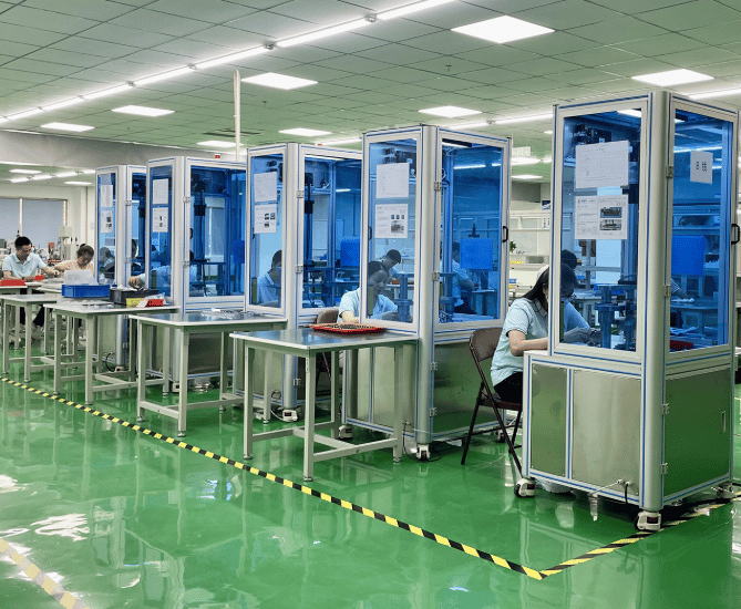 a factory floor with a lot of people working on machines