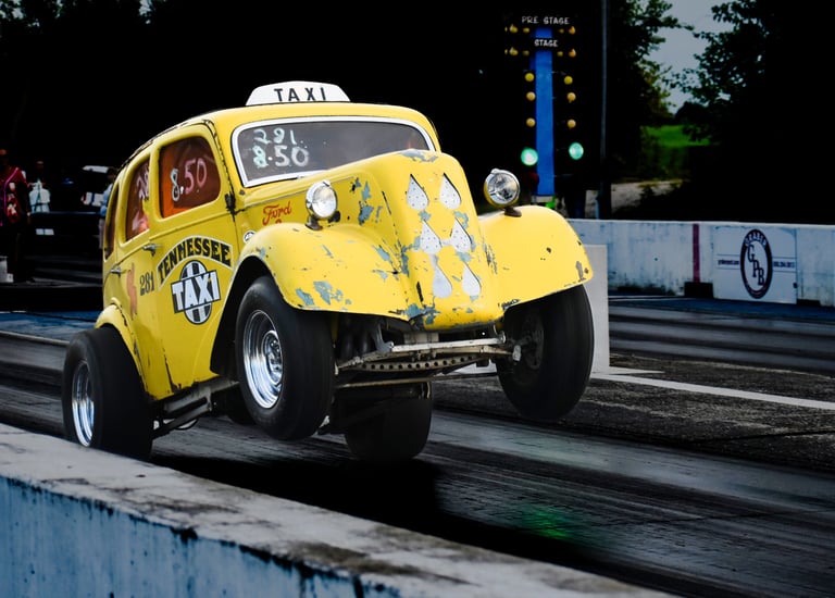 YELLOW OLD TAXI STYLE DRAG CAR WITH WHEELS UP