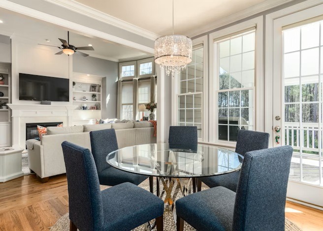 a dining room with a glass table and chairs