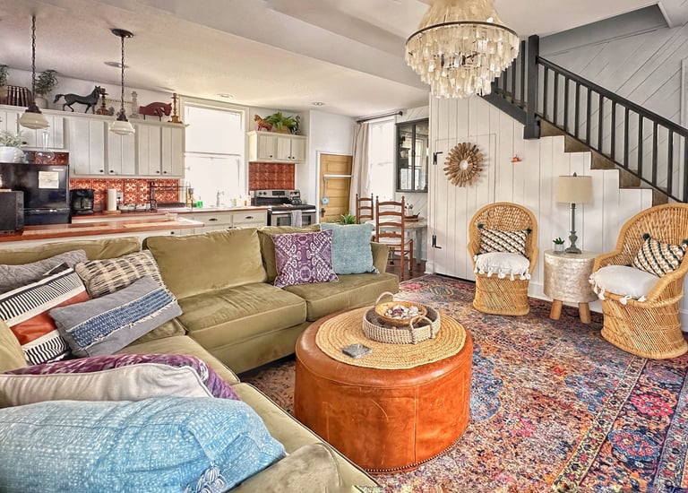 living room with green sectional and galley kitchen of 2123 rivermont's carriage house