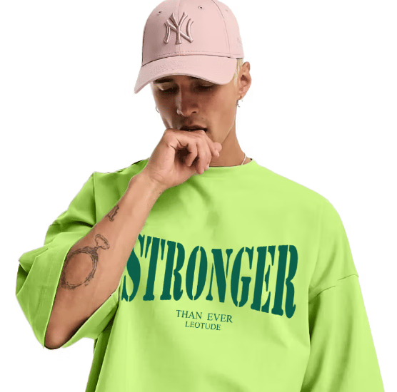 a man in a green shirt and a pink hat