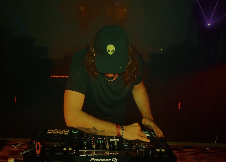 a man in a hat and a hat on a dj booth