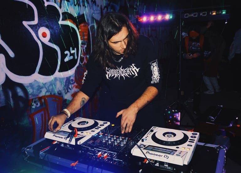 a man in a black shirt is playing a dj - Creechur