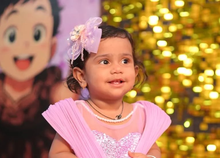 Elegant birthday setup with metallic balloons, floral decor, and photo backdrop by Amika Events in Pune