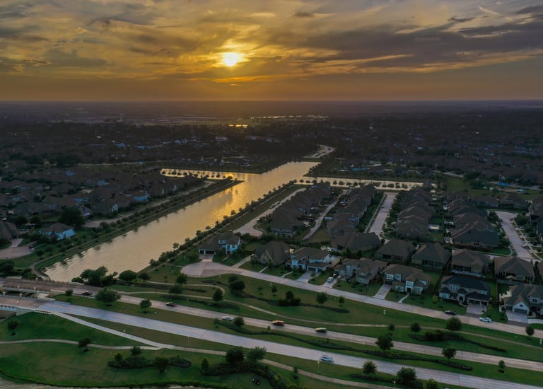 A sunset image of a man made lake in the form of a cross near Towne Lake Memorial Park, Cypress, TX