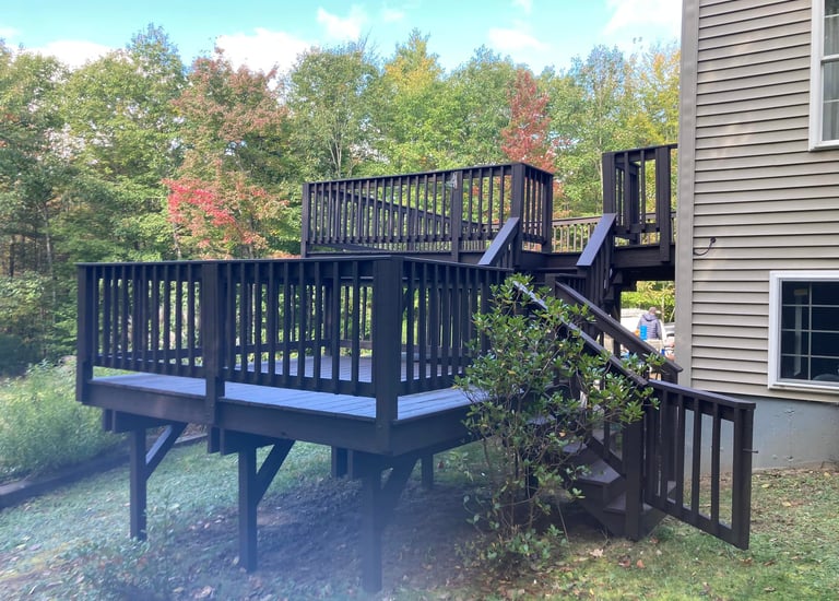 a wooden deck with a wooden deck and stairs