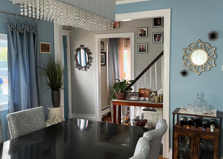 a dining room table with chairs and a chandelier