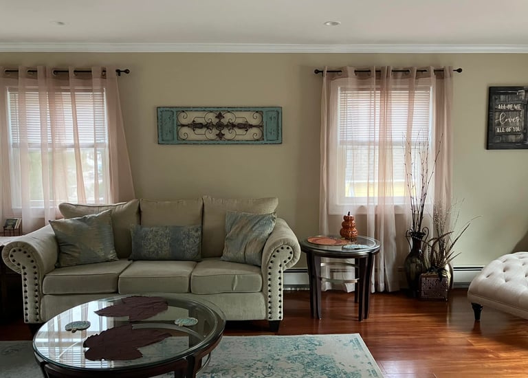 a living room with a couch and chairs