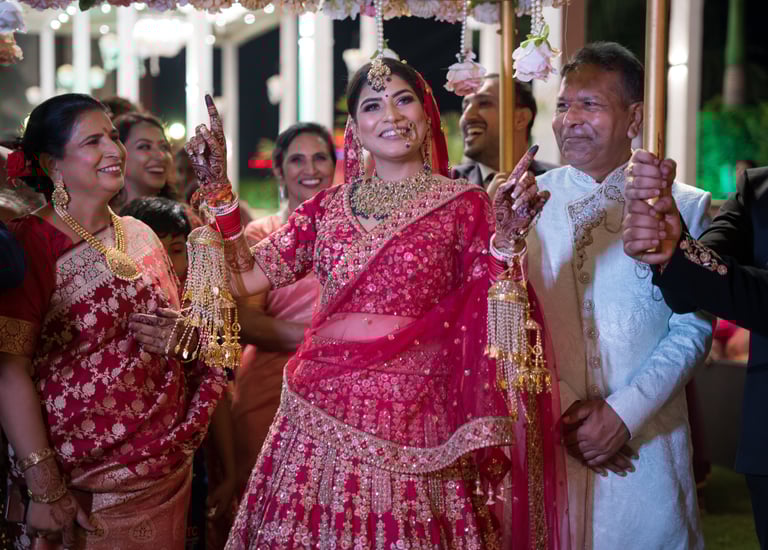 Bride in red lehenga at her wedding.