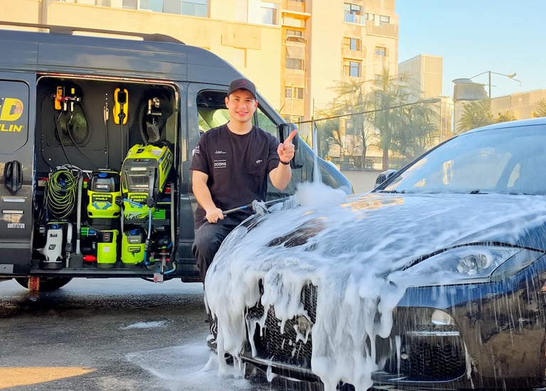 “Mobile detailing expert cleaning car interior with vacuum”